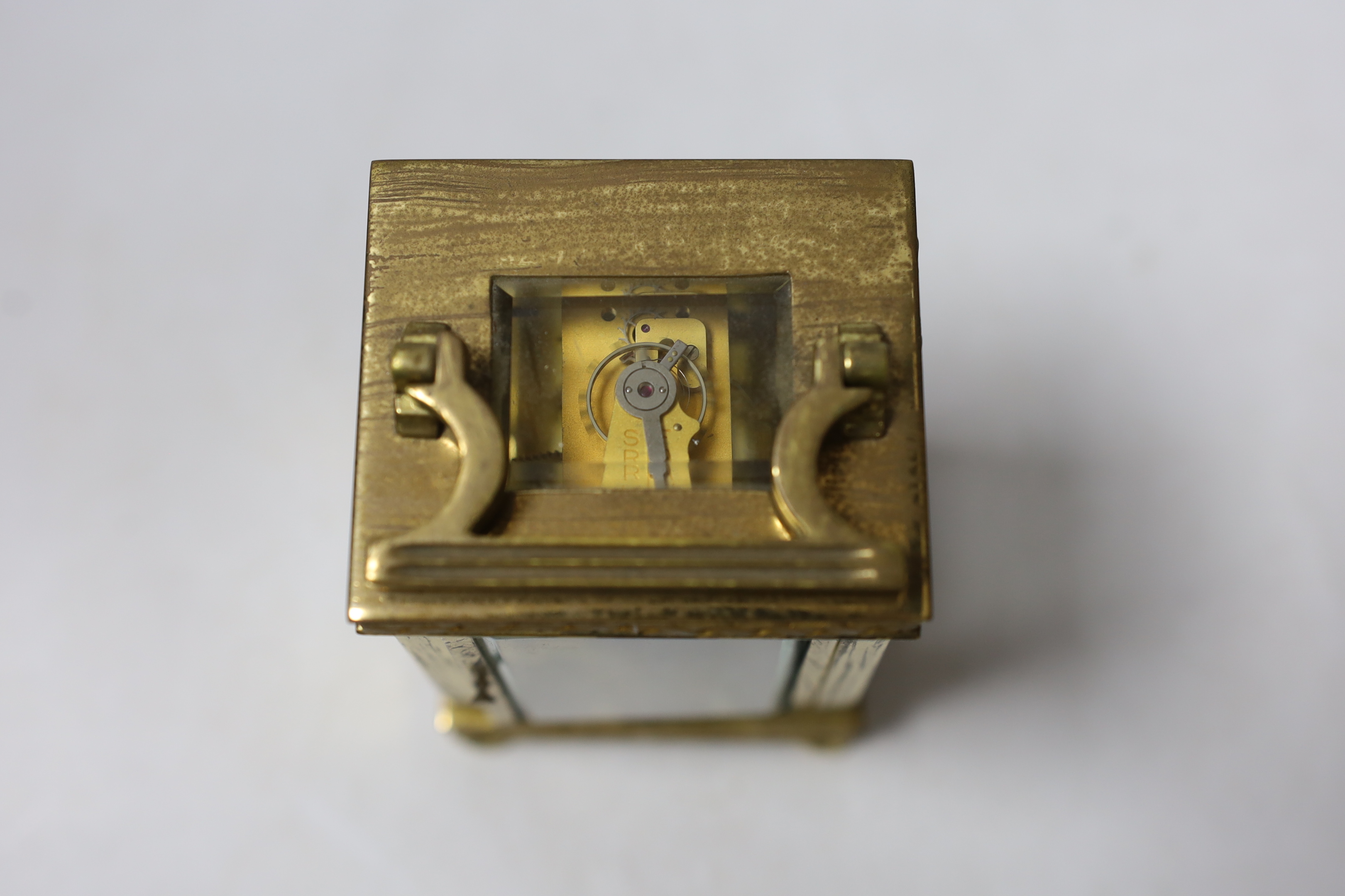 An Edwardian blind fretwork brass carriage timepiece, 12cm, in cloth covered case